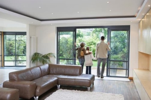 Family enjoying outdoor living space with patio door replacement Symbolizing New Windows and Doors